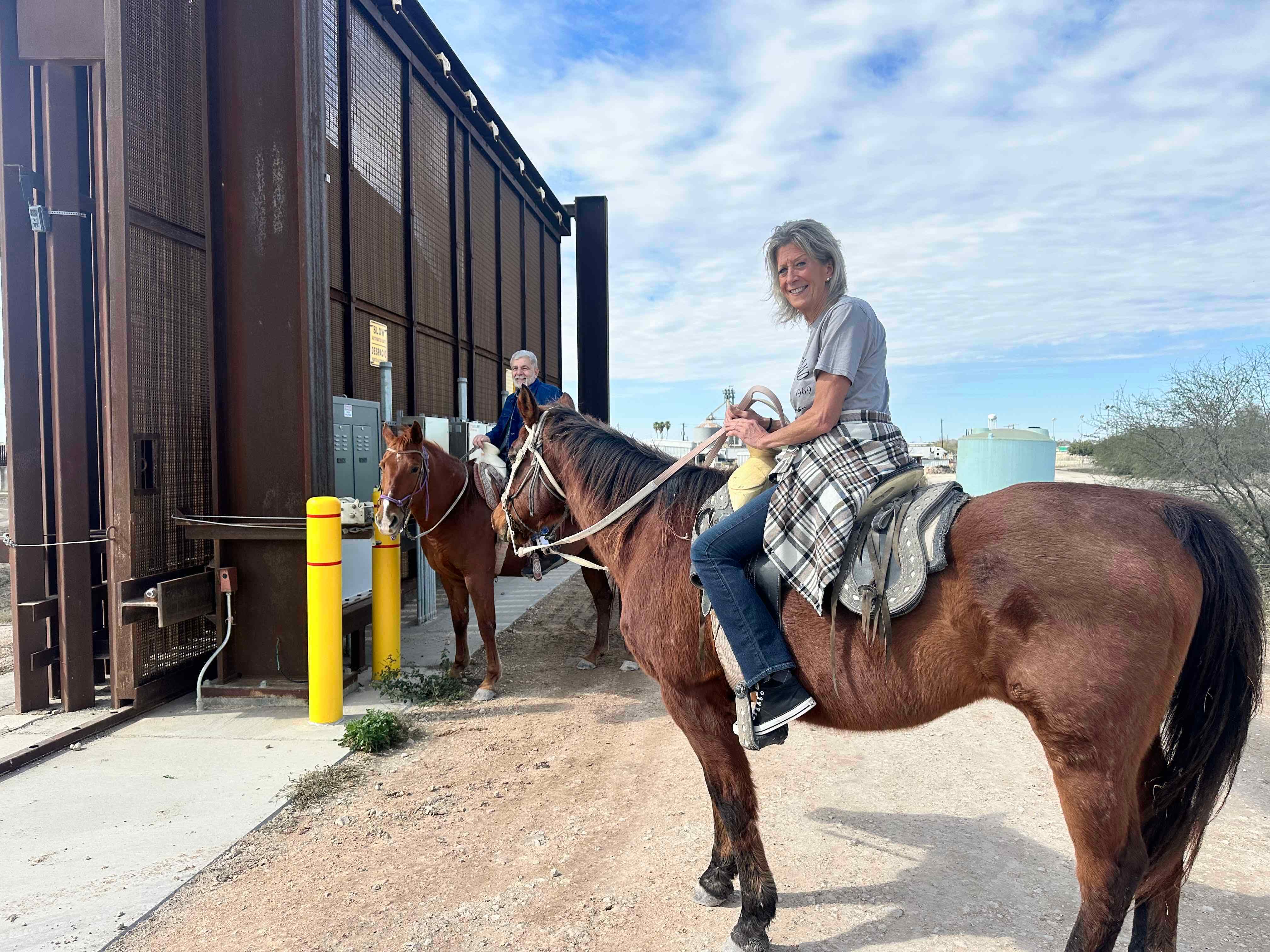 A Couple Standing at the Border Fence Gate